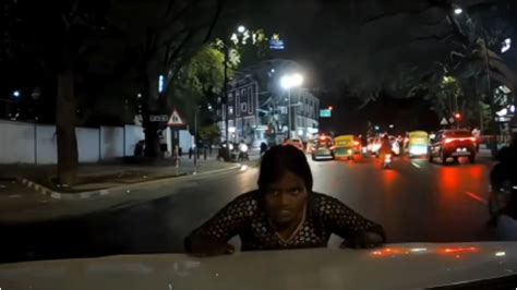 Woman fakes accident by falling in front of moving car in Bengaluru. Video.